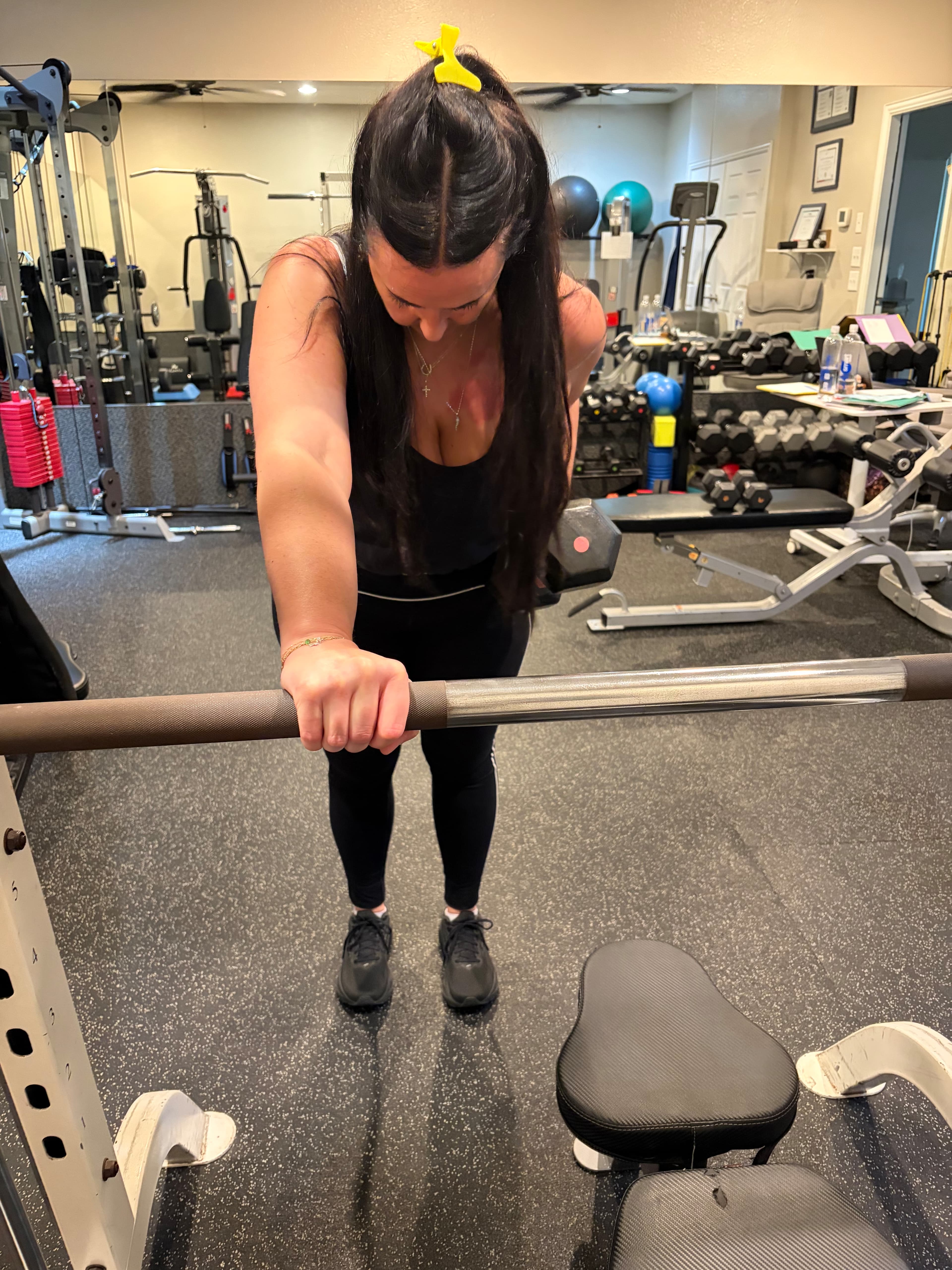 Client performing a barbell deadlift in the studio