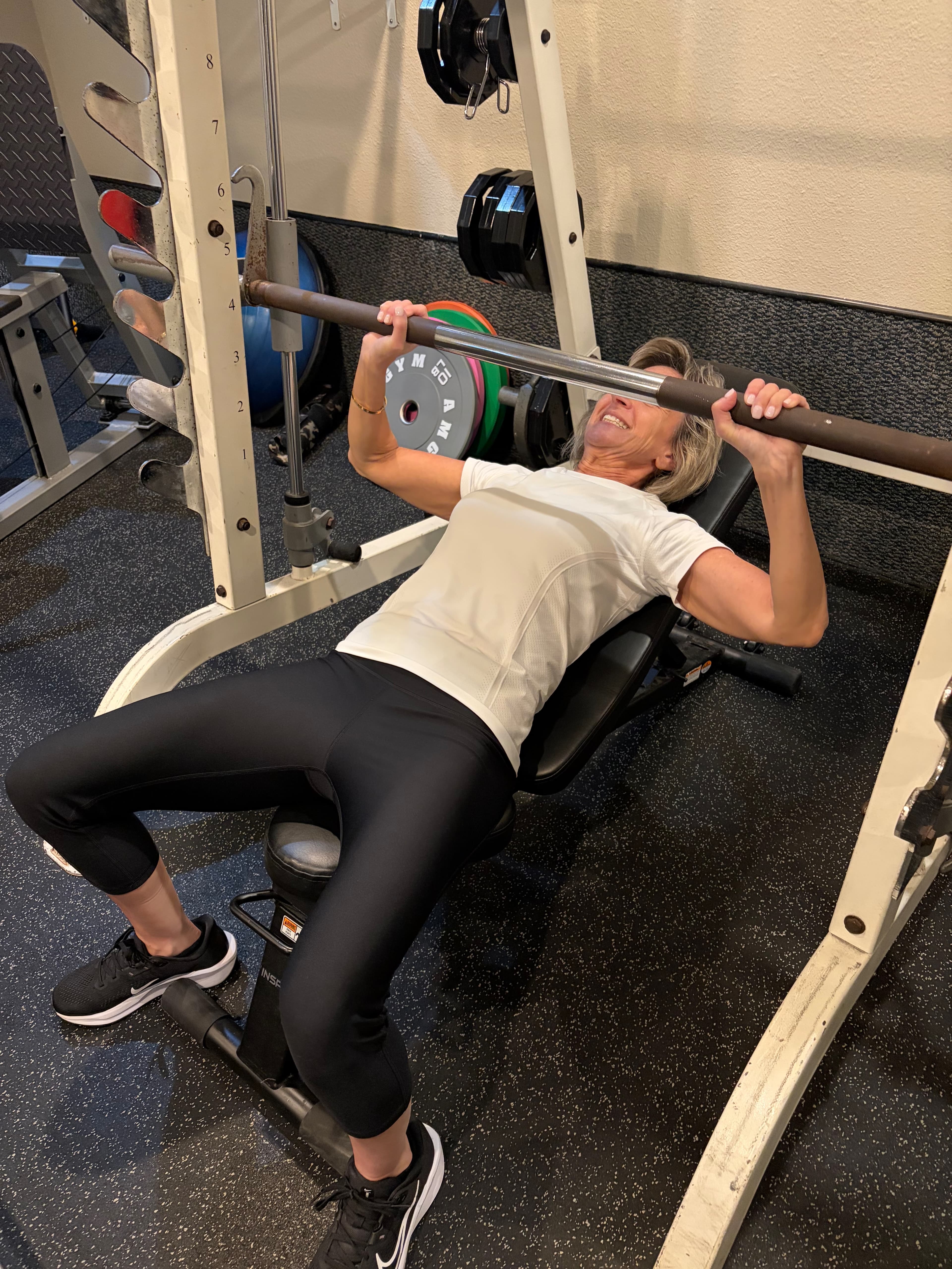 Client doing bench press with a barbell