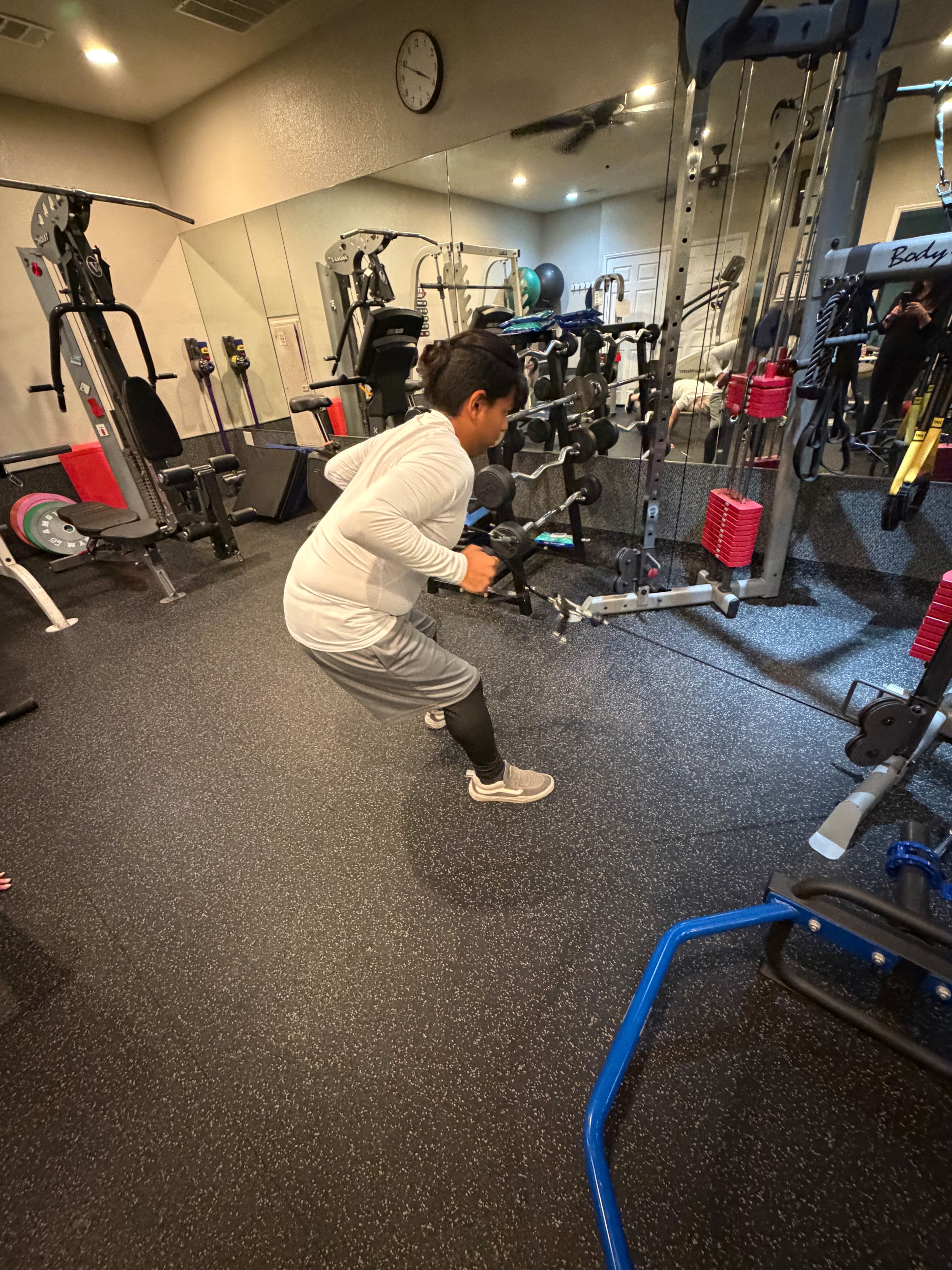 Client performing cable squats in the studio