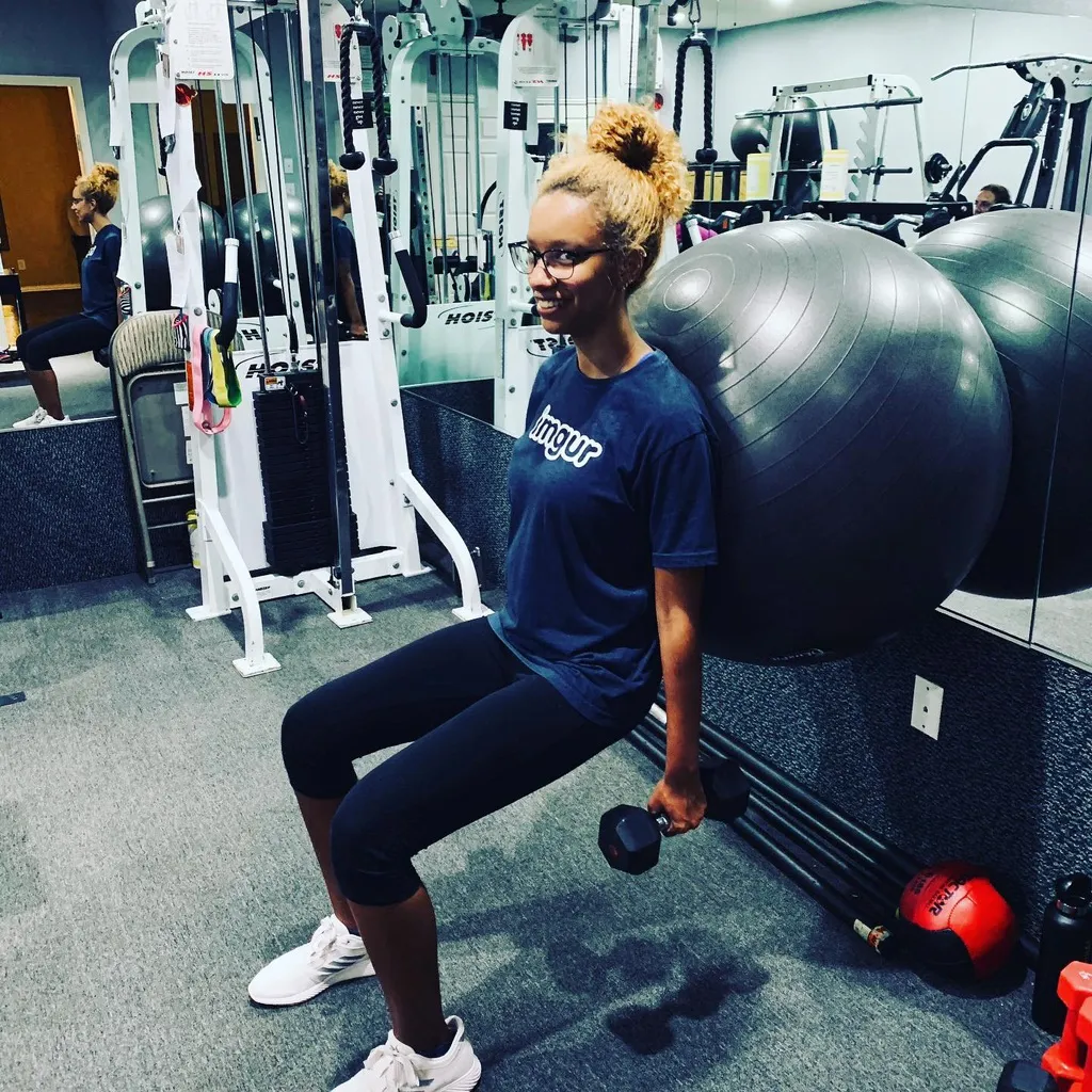 Client doing squats with a stability ball