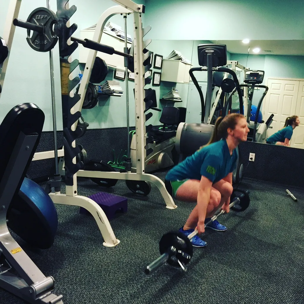 Client performing a deadlift in the studio